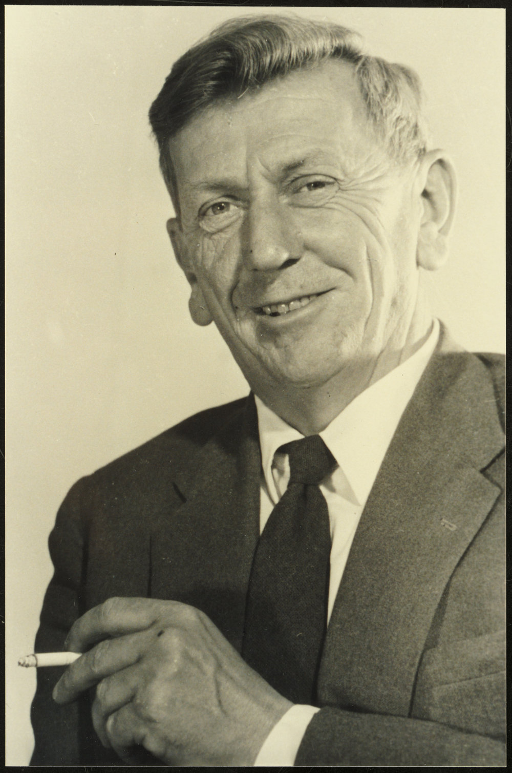 C.P. McMeekan (1908-1972) in a studio portrait, smoking