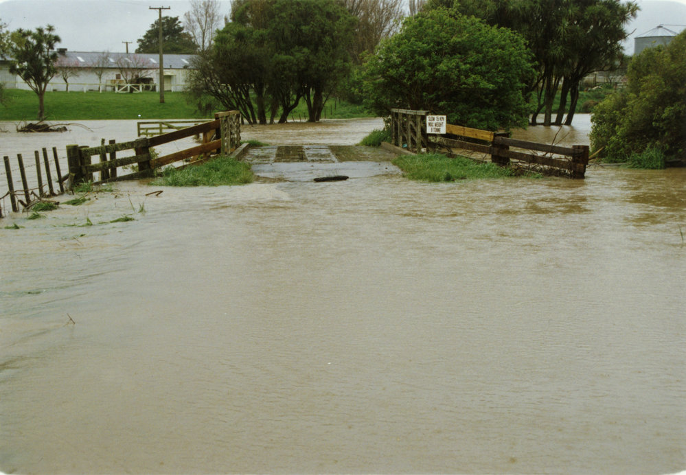Turitea stream in flood. 4. Enveloping the bridge