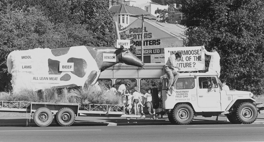 Dunedin Parade with 'Invermoose'. 1. Truck and flatbed trailer on road at a community event