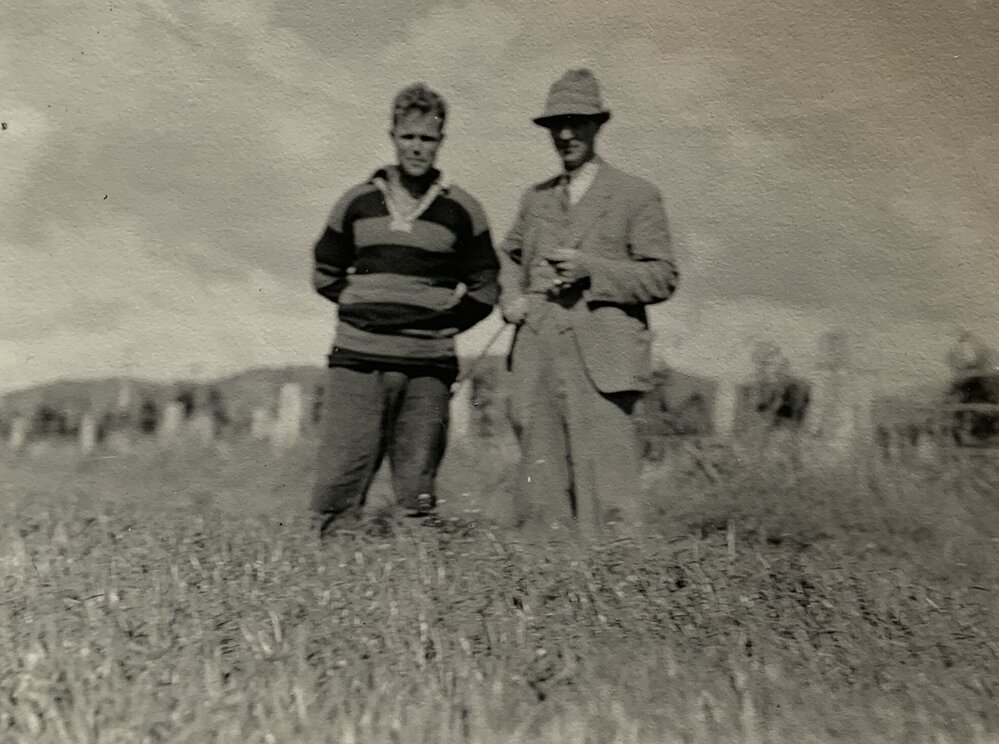 Farmer and son standing in a field - 2 of 2