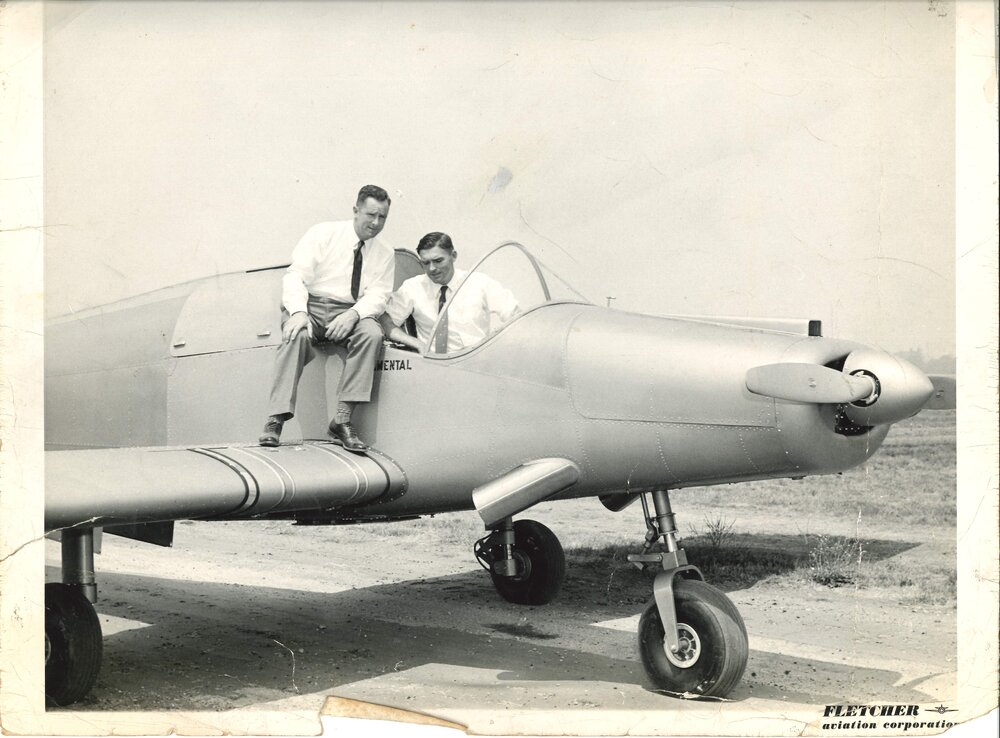 Plane on tarmac with two men