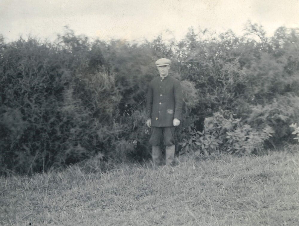 Man standing before bushes