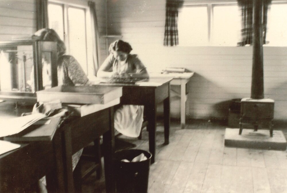Herbage workers at desks
