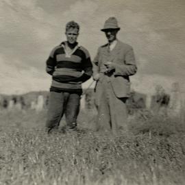 Farmer and son standing in a field - 2 of 2