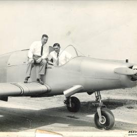 Plane on tarmac with two men