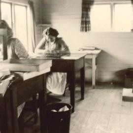 Herbage workers at desks