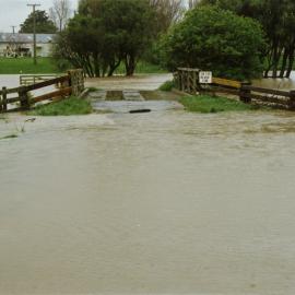 Turitea stream in flood. 4. Enveloping the bridge