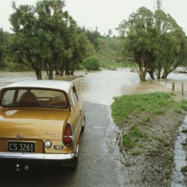 Turitea stream in flood. 7. Stranded car