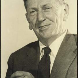 C.P. McMeekan (1908-1972) in a studio portrait, smoking